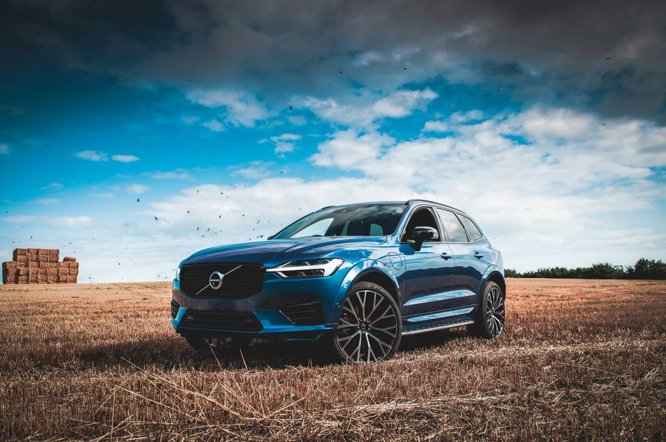 Blue Volvo XC60 seen from the front in a harvested field